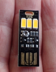 This 2.3g LED light is fitted with light sensitive circuitry that causes it to switch on as daylight fades. The 5v 0.5W light has three LEDs emitting 3200 kelvin. However I feel this is the least suited of LED lights for backpacking use