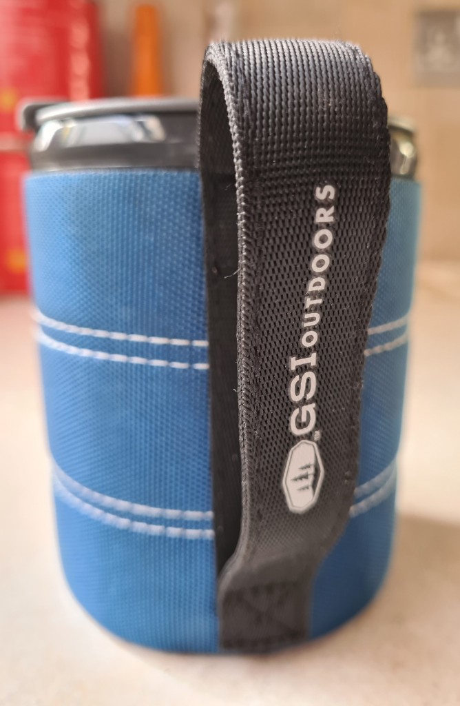 Mug has a 1mm thick neoprene sleeve with tough cordura covering. The webbing handle can be gripped in normal fashion, or a hand slipped inside it. This handle allows for easier packing